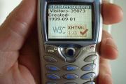 hand holding a phone displaying valid XHTML page