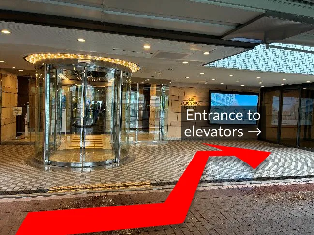 photo with the main hotel entrance (left) and entrance for the elevators (right)