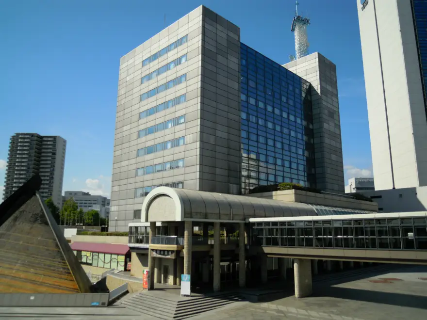 [Photo of the front of the conference center]